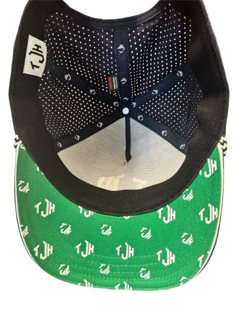 The inside of the #TeamJHall performance snapback, showing the mesh back and the white TJH logo clearly visible throughout the bottom of the green bill.