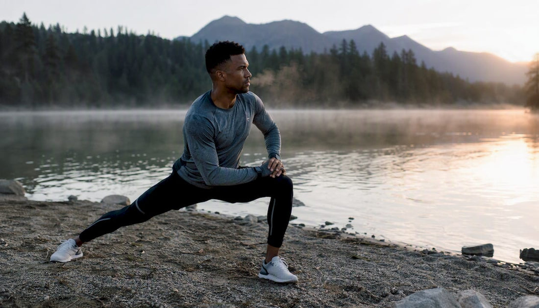 Athlete stretching outdoors at dawn