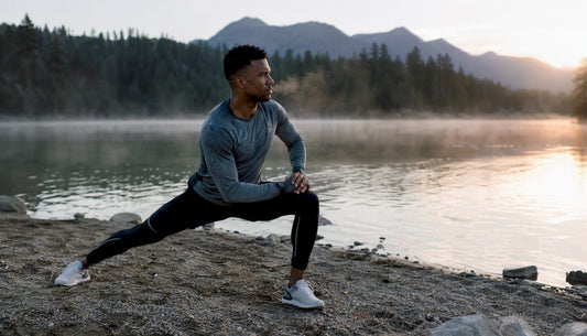 Athlete stretching outdoors at dawn
